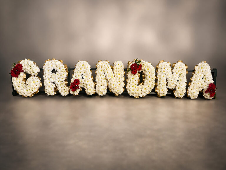 Fresh flower lettering funeral tribute spelling Grandma, Eastbourne florist