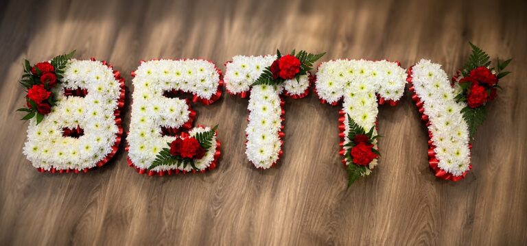 Name letter funeral tribute with red roses, Eastbourne